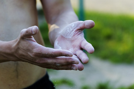 The young man sprinkle his hands with powderの写真素材
