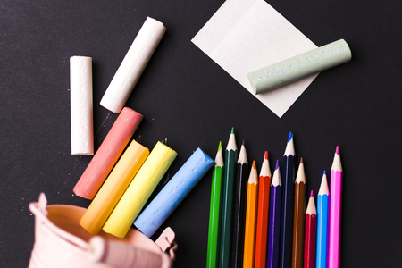 Pencils, crayons, magnifying glass. School.