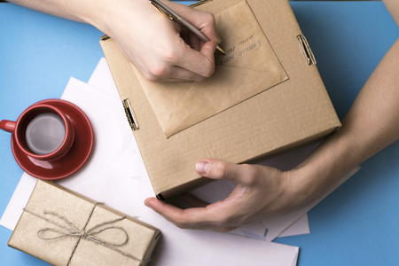 A man signs a gift. Mail. Card.の写真素材
