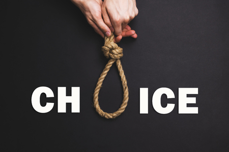 The man tightens the noose jn black backgroundの写真素材