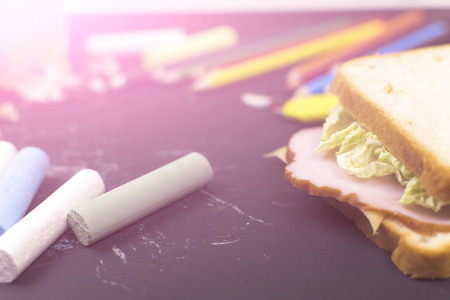 Sandwich, crayons, pencils. School lunch. A school break.の写真素材