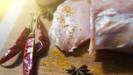 Fresh meat and spices on a wooden Boardの写真素材