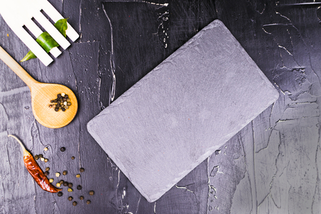 Different Cutlery and spices on a dark textured backgroundの写真素材