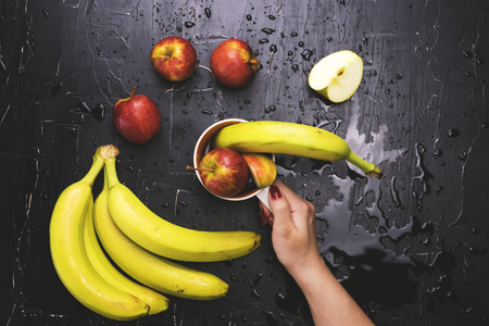 Fruit in a circle on a dark background. Concept of fresh juice and fruit tea.の写真素材