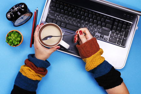 The girl works at the computer. Colored background. The concept of freelancing.の写真素材
