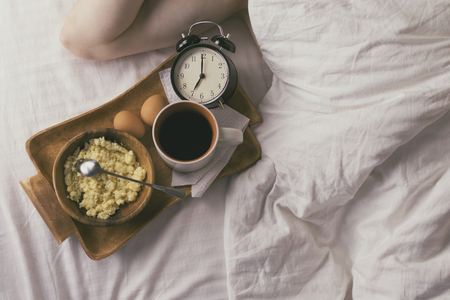 Young man having Breakfast in bed in the morningの写真素材