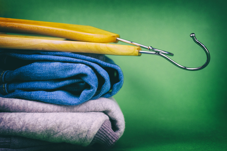 Hangers and denim on a colored background. Made in a vintage performance.の写真素材