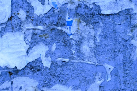 Dirty old speckled texture of fragments of old advertisements.の写真素材