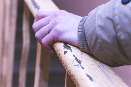 The man holding his hand over the railing.の写真素材