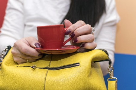 Girl holding her bag. Search for items in the bagの写真素材