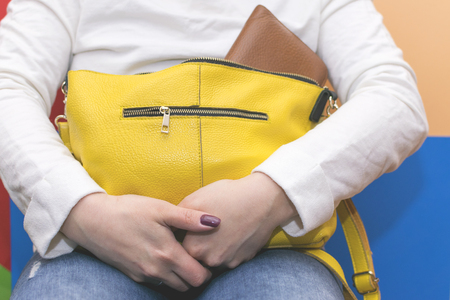 Girl holding her bag. Search for items in the bagの写真素材