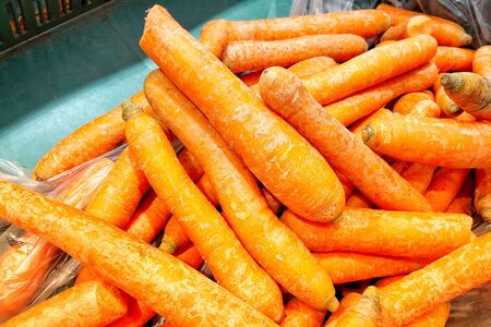 Fresh carrots and potatoes in the store. A close-up. Mobile photo