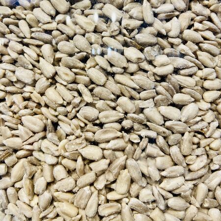 Different nuts and dried fruits in the package in the supermarket. A close-up. Mobile photo.の写真素材