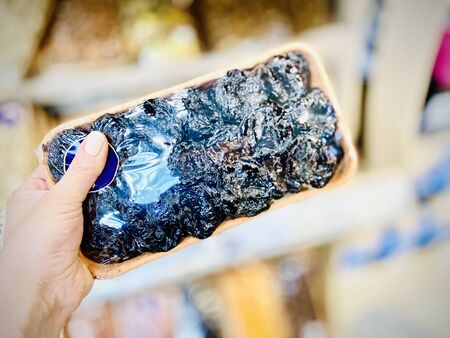 Different nuts and dried fruits in the package in the supermarket. A close-up. Mobile photoの写真素材
