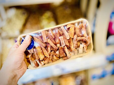 Different nuts and dried fruits in the package in the supermarket. A close-up. Mobile photoの写真素材