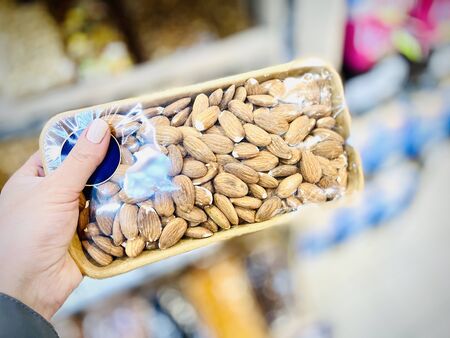 Different nuts and dried fruits in the package in the supermarket. A close-up. Mobile photoの写真素材