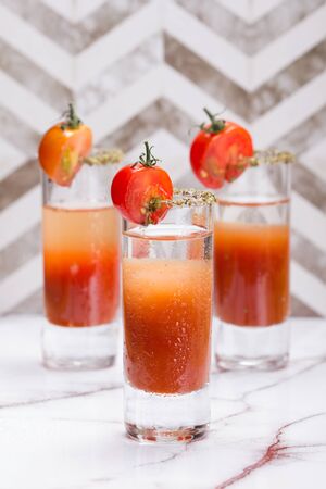 Bloody mary shots garnish with half a tomatoの写真素材