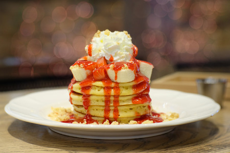 Pancakes with strawberries banana and whip cream topping.の写真素材