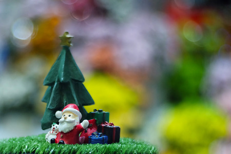 Santa doll with christmas tree in christmas day on blurred background, Image out of focusの写真素材