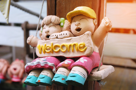 Baby doll couple made of clay with "welcome"の写真素材