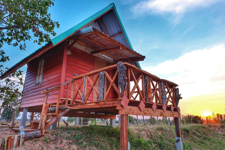 Wooden house on sunset backgroundの写真素材