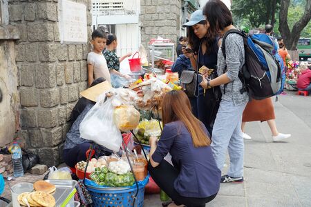 HO CHI MINH CITY, VIETNAM - January 13, 2018 : Asia woman buy food, street food in Ho Chi Minh City, South Vietnamのeditorial素材