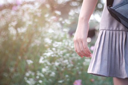 Close-up hand of lonely girl. Woman alone on the nature at sunlightの写真素材