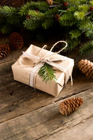 Gift cones and fir branches on wooden backgroundの写真素材