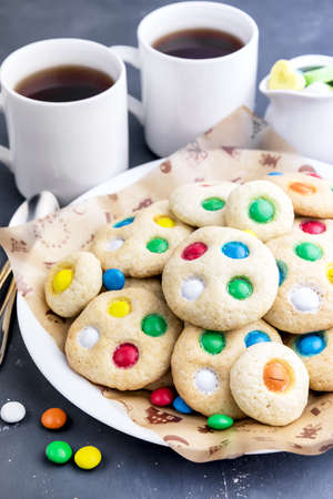 Homemade cookies with colorful chocolate candiesの写真素材