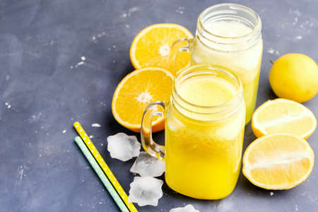 Orange and lemon fresh juice in jarsの写真素材