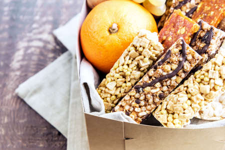 Muesli bars orange grapes on wooden backgroundの写真素材