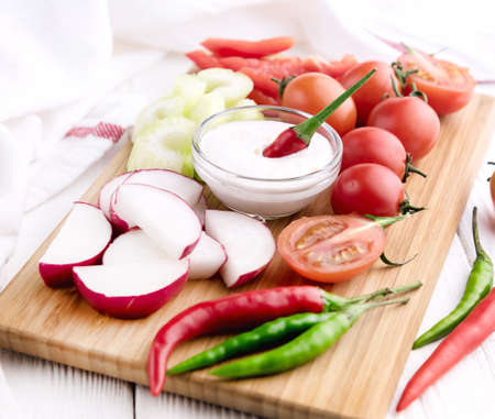 Radish Celery Pepper Tomatoes Wooden backgroundの写真素材