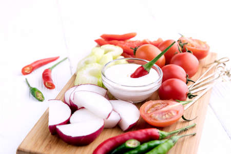 Radish Celery Pepper Tomatoes Wooden backgroundの写真素材