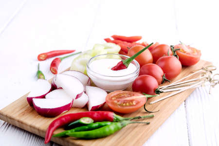 Radish Celery Pepper Tomatoes Wooden backgroundの写真素材