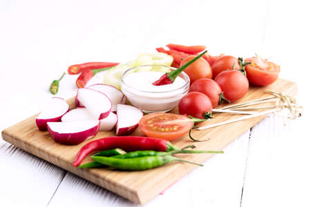 Radish Celery Pepper Tomatoes Wooden backgroundの写真素材