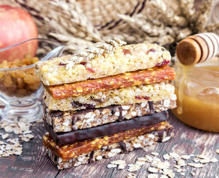 Granola Dried apricot bars Apple Wooden backgroundの写真素材