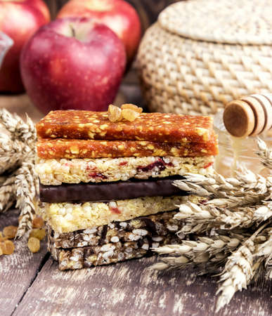 Granola Dried apricot bars Apple Wooden backgroundの写真素材