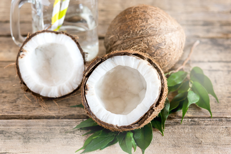 Coconuts and Glass Jar with Coconut Water Old Wooden Background Straw Horizontalの写真素材