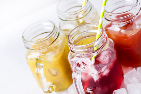 Variety of Tasty Juices in Glass Jars Mugs Healthy Beverages Drinks White Background Horizontalの写真素材