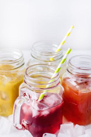 Variety of Tasty Juices in Glass Jars Mugs Healthy Beverages Drinks White Background Verticalの写真素材