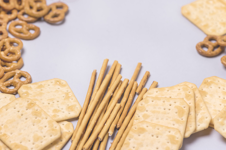 Salty Crackers Sticks Pretzels Top View Above Blue Background Party Snacks Mix Variety of Tasty Crackers for Beer Flat Lay Tonedの写真素材