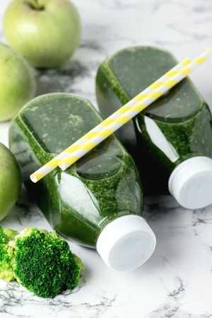 Healthy Detox Green Smoothie with Green Apples and Ripe Broccoli in Bottles Healthy Diet Food Drink Vertical Copy Space White Backgroundの写真素材