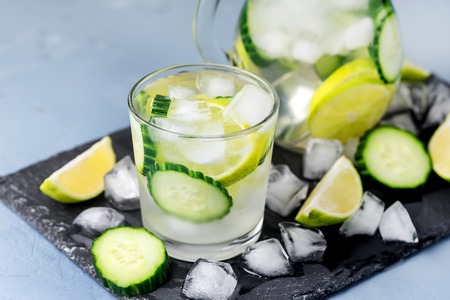 Cold and Refreshing Infused Detox Water with Lime and Cucumber in a Glass With Ice Cube Healthy Detox Drink Horizontalの写真素材