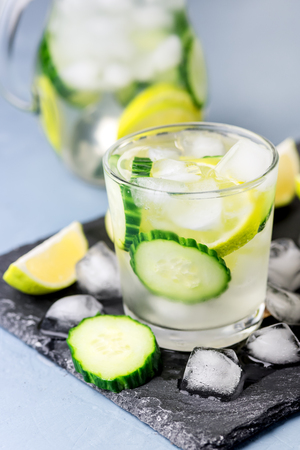 Cold and Refreshing Infused Detox Water with Lime and Cucumber in a Glass With Ice Cube Healthy Detox Drink Verticalの写真素材