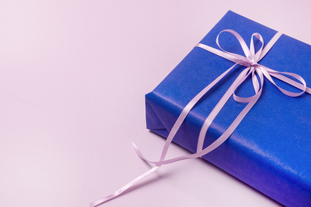 Background with Gift Boxes in Blue Wrapping Paper with Ribbons Lying on a Pink Background Horizontal Top View Flat Lay Presents Boxes Holidays Shopping Conceptの写真素材