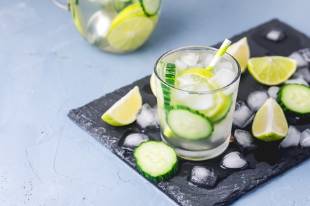 Cold and Refreshing Infused Detox Water with Lime and Cucumber in a Glass With Ice Cube Healthy Detox Drink Copy Space Horizontalの写真素材