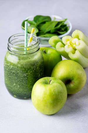 Glass Jar of Healthy Green Smoothie Detox Drink wirh Green Apple Celery and Raw Spinach Diet Beverage Verticalの写真素材