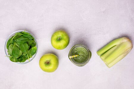 Glass Jar of Healthy Green Smoothie Detox Drink with Green Apple Celery and Raw Spinach Diet Beverage Flat Layの写真素材