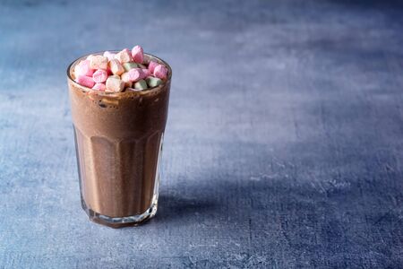 Glass of Tasty Chocolate Milk Shake with Marshmallow on Blue Background Tasty Cocoa Horizontal Copy...