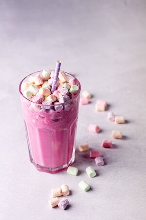 Glass of Tasty Fruit Smoothies or Milk Shake Decorated With Marshmallow Above Vertical